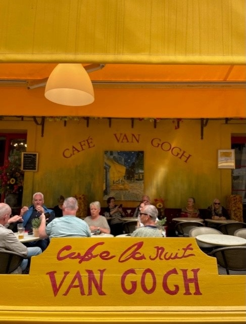Kahvila ranskalaisessa kaupungissa. Keltaisessa seinässä lukee Cafe van Gogh.
