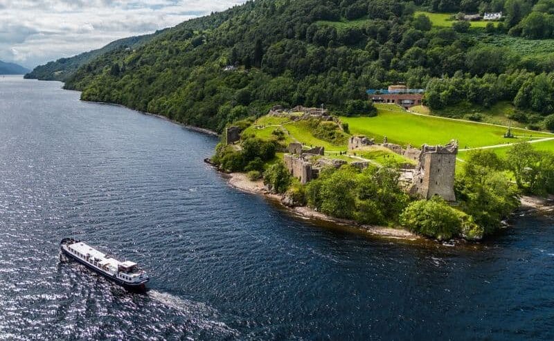 Scottish Highlander Cruising Past Urquhart Castle August europeanwaterways